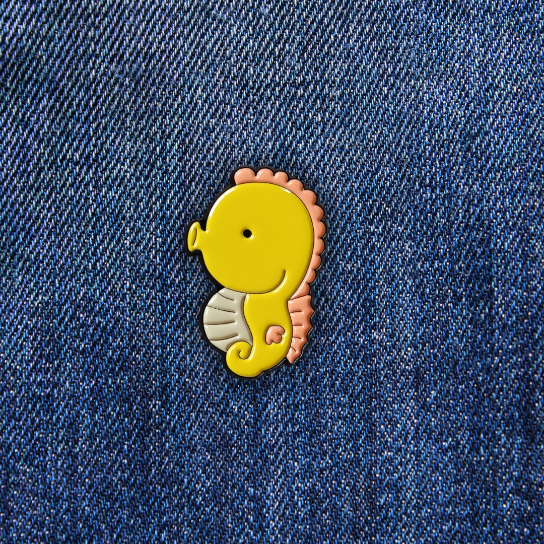 Pins Hippocampe jaune sur un jean