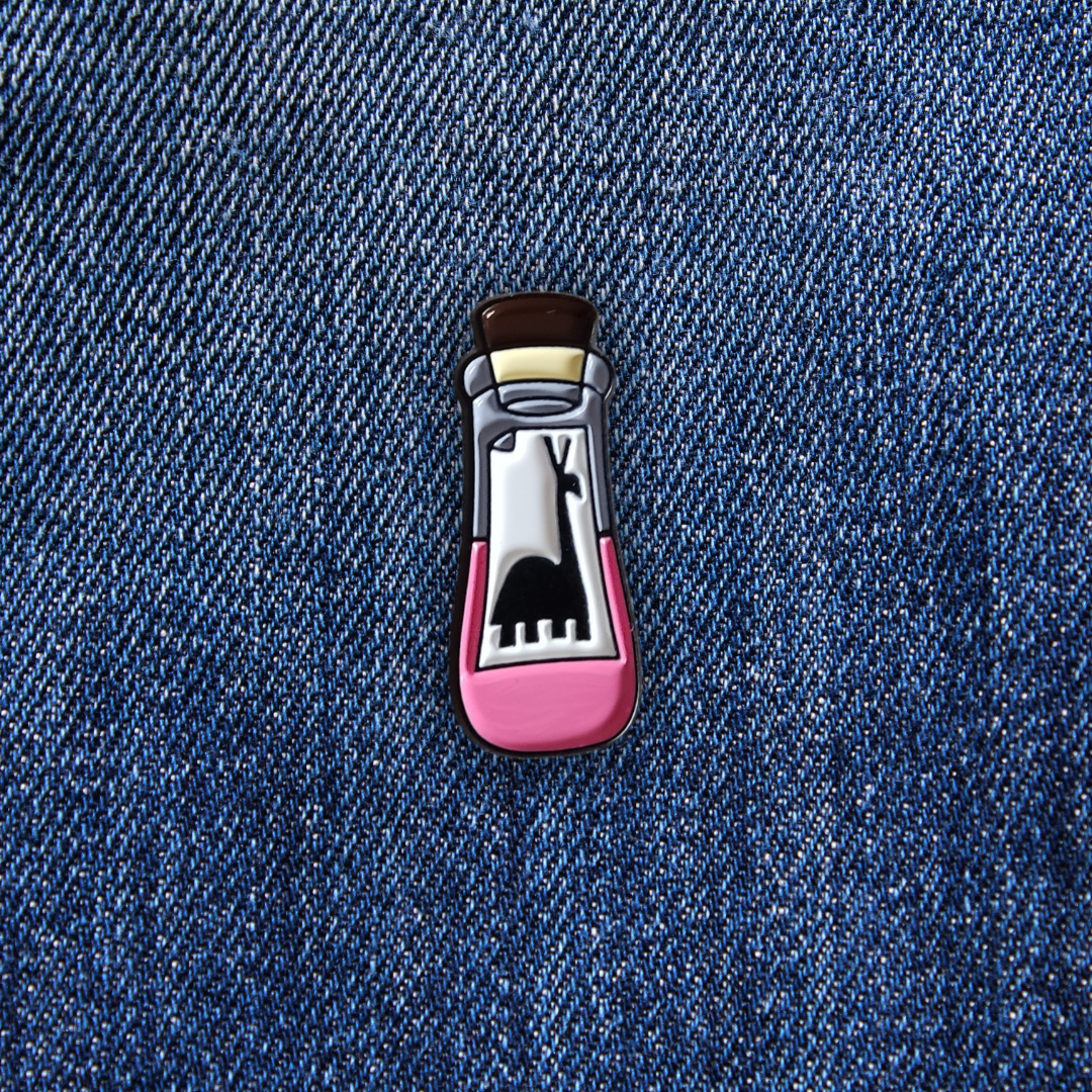 Pins Fiole Kuzco sur un jean