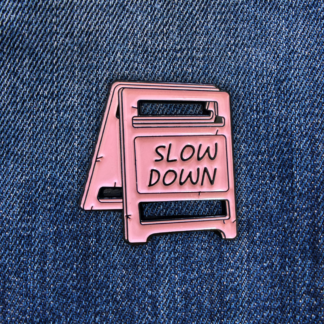 Pins SLOW DOWN sur un jean