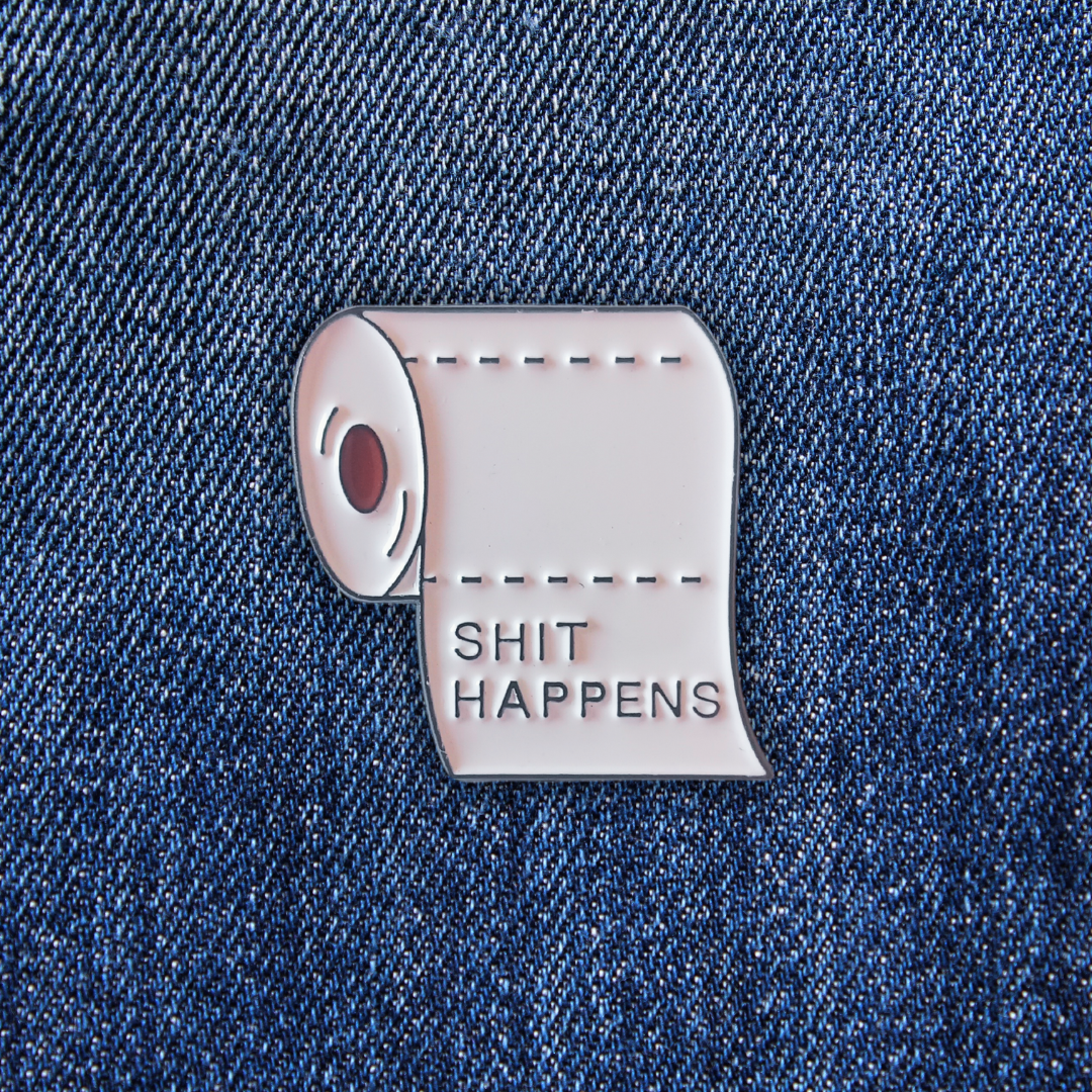 Pins Shit Happens sur un jean